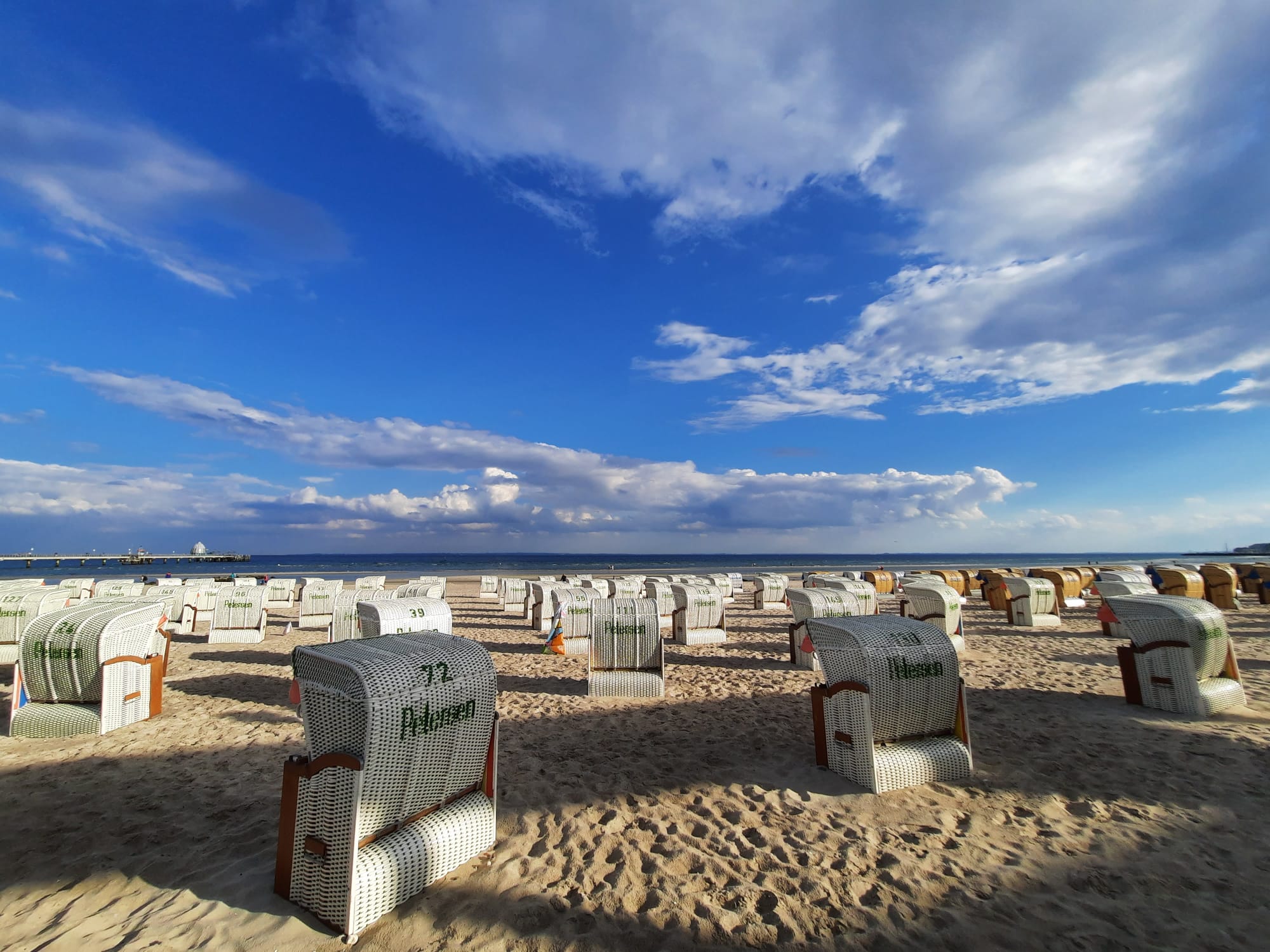 Strandkörbe am Grömitzer Ostseestrand unter weitem Himmel